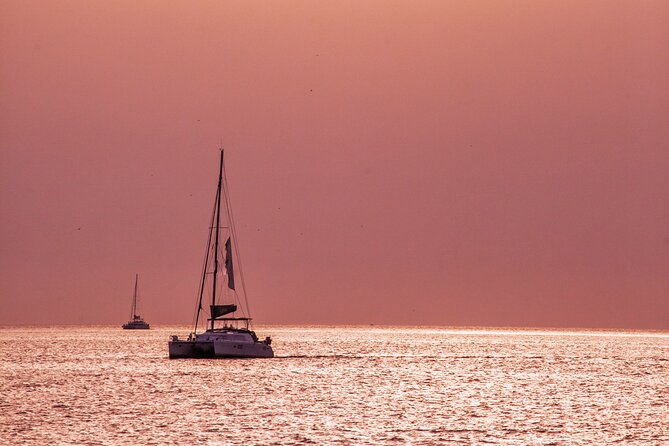 Deluxe Santorini Sailing with BBQ and Drinks Shared Tour - A catamaran cruise that turns Santorini into one long view