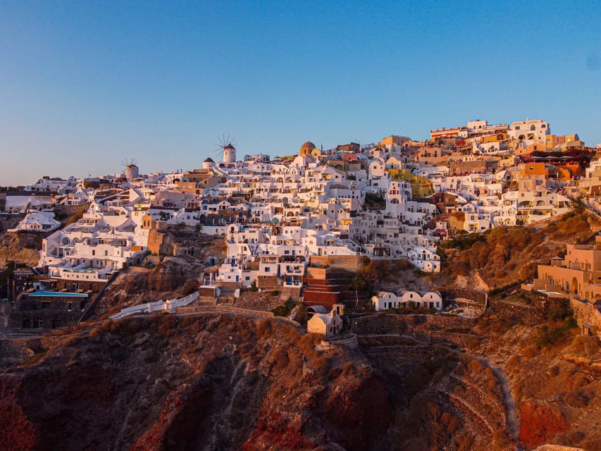 From Fira: Santorini Highlights Minibus Tour with Oia Sunset - Perissa Beach free time: swim, sunbathe, and buy your own lunch