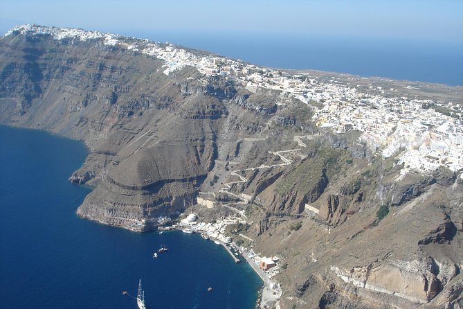 The caldera cliff and the white villages along the rim, seen from the air