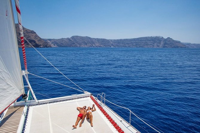 Sailing Catamaran Cruise in Santorini with BBQ, Drinks and Transfer - Snorkeling gear and comfort rules you should know