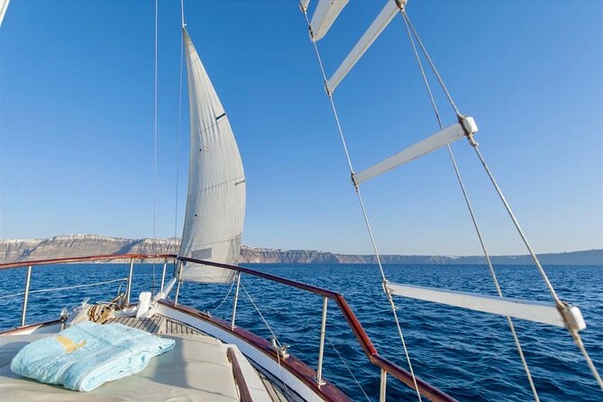 Santorini Caldera Day Traditional Cruise with Meal and Drinks - Black Mountain, Indian Rock, and the volcanic coastline views