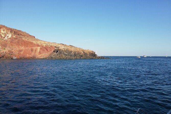 Santorini Catamaran Cruise with Fresh Meal and Open Bar - Stop 1: Red Beach, Photos and a Geology Lesson in Color