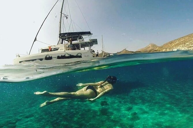 Santorini Catamaran Cruise with Fresh Meal and Open Bar - Stop 2: White Beach, the Crystal-Water Break You Cannot Replicate on Foot