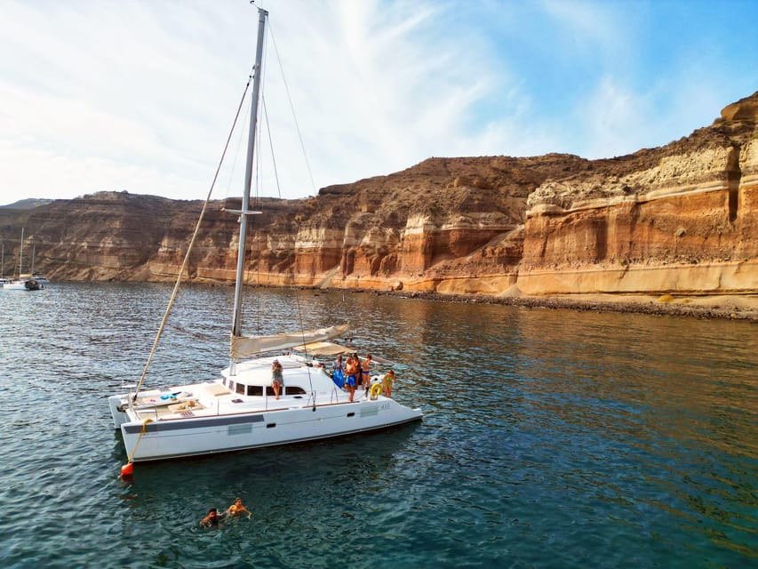 Santorini: Catamaran Cruise with Greek BBQ and Drinks - Getting There: Vlychada Marina, Hotel Pickup, and Start Times
