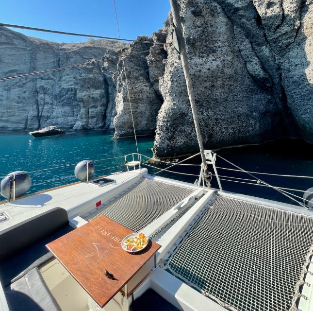 Santorini Catamaran Cruise with Swimming, Meal and Open Bar - Thirassia island swim and snorkeling, then a meal that happens on the water