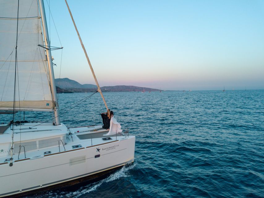 Santorini Catamaran Cruise with Swimming, Meal and Open Bar - First swim stop at Red Beach, volcanic water meets easy snorkeling