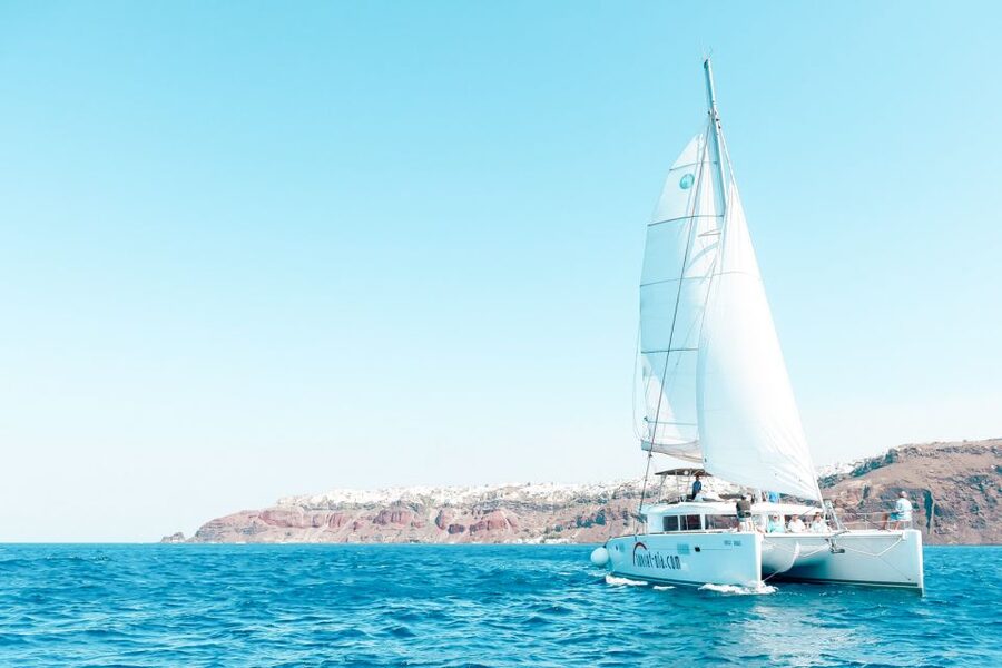 Santorini: Catamaran Tour with BBQ Meal and Unlimited Drinks - Passing Volcanic Rock Formations for Photo Moments