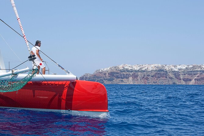 Santorini Cruise on Catamaran with BBQ & Open Bar - Stop 1 at the volcano hot springs: swimming in black rock country
