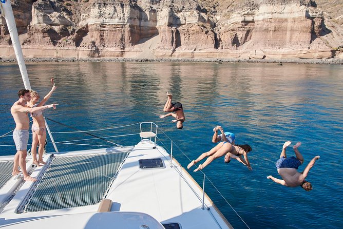 Santorini Gold Catamaran Cruise with BBQ, Drinks and Hotel Pickup - Snorkeling gear, towels, and how to get the most from each swim