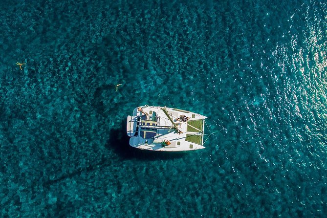 Santorini Half Day Catamaran Private Cruise incl. Meal, Drinks & Free Transport - A private catamaran day that actually saves you energy