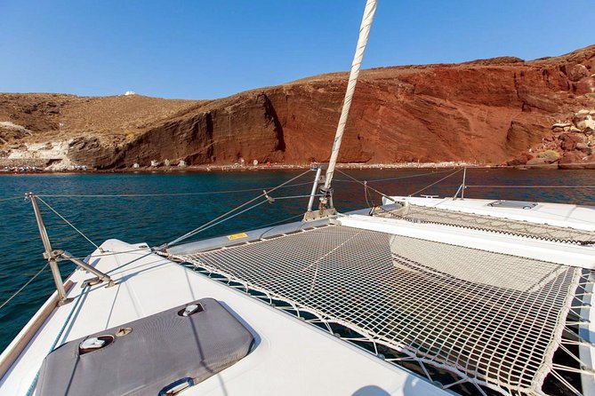Santorini Half Day Catamaran Private Cruise incl. Meal, Drinks & Free Transport - Aspronisi and the white island feeling: where the sea shows geology layers
