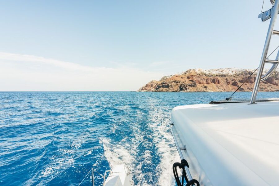 Santorini: Luxury Catamaran Day Trip with Meal and Open Bar - Volcano islands, Akrotiri lighthouse, and sailing below Fira