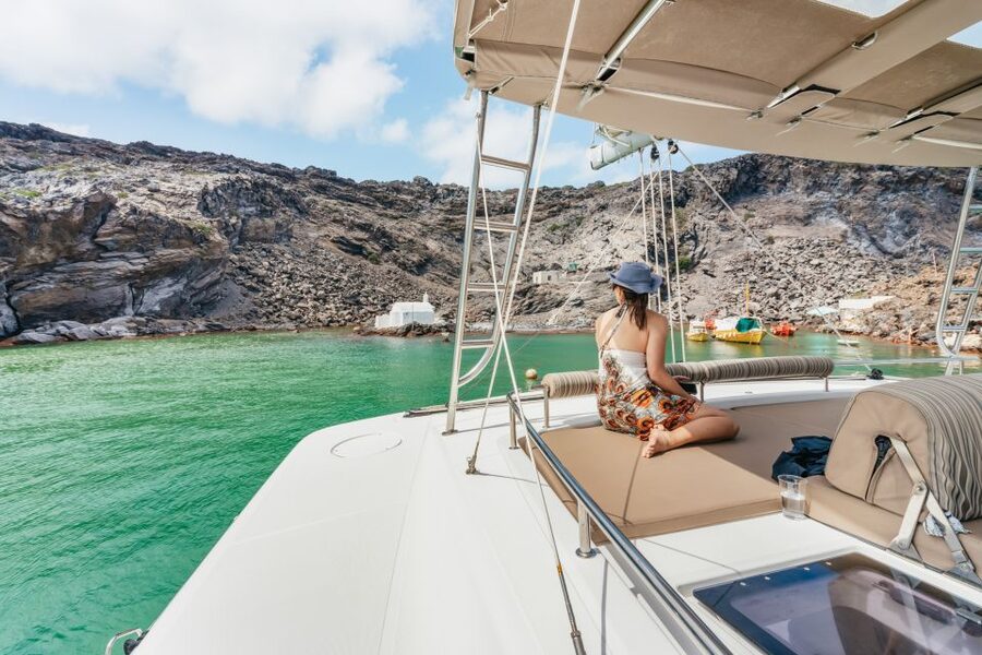 Santorini: Luxury Catamaran Day Trip with Meal and Open Bar - Sunbathe time, music, and photo moments in the caldera light