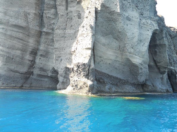 Santorini Luxury Catamaran Sunset Cruise with BBQ, Drink and Transfer - Red Beach snorkeling and watching the cliffs close up