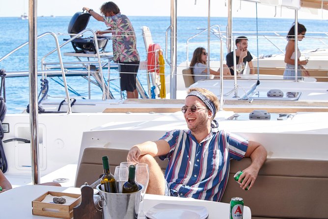 Santorini Platinum Catamaran Cruise with Meal, BBQ and Open Bar - Crew energy, music, and sunset timing