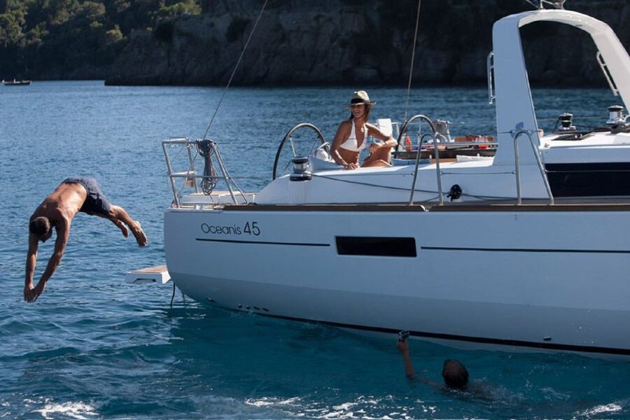 Santorini: Private Caldera Sailing Trip with Open Bar & Meal - Red Beach Start: Sailing Out From a Dramatic First Stop