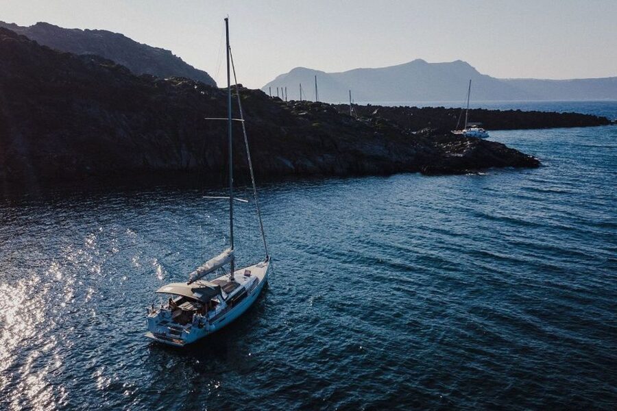 Santorini: Private Caldera Sailing Trip with Open Bar & Meal - Entering the Caldera Below the Venetian Light House