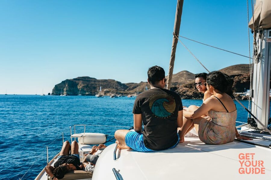 Santorini: Private Catamaran Tour with BBQ Meal and Drinks - Mesa Pigadia swim and snorkeling: where the black rocks matter